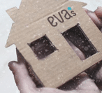 safe.shelter.image.small Cardboard house with Eva's logo on it, in someone's hands.