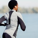 Black woman jogging by lake