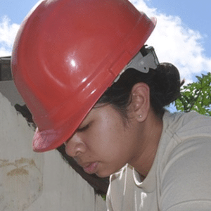 Young woman with construction helmut on