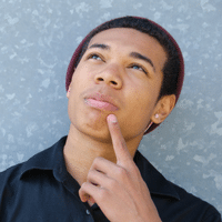Young man pondering with finger on his chin