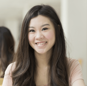olivia.story_.image_.2 Young woman, Olivia, with long dark hair looking at the camera and smiling