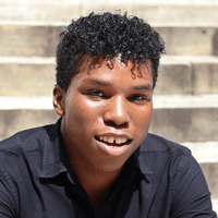 Young man with dark hair looking at camera
