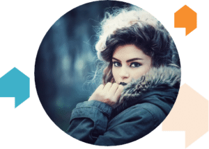 Young woman in winter coat looking at camera.