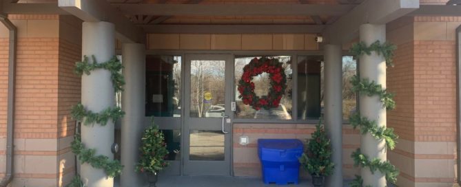 A photo of the entrance of Eva's Place decorated for the holidays