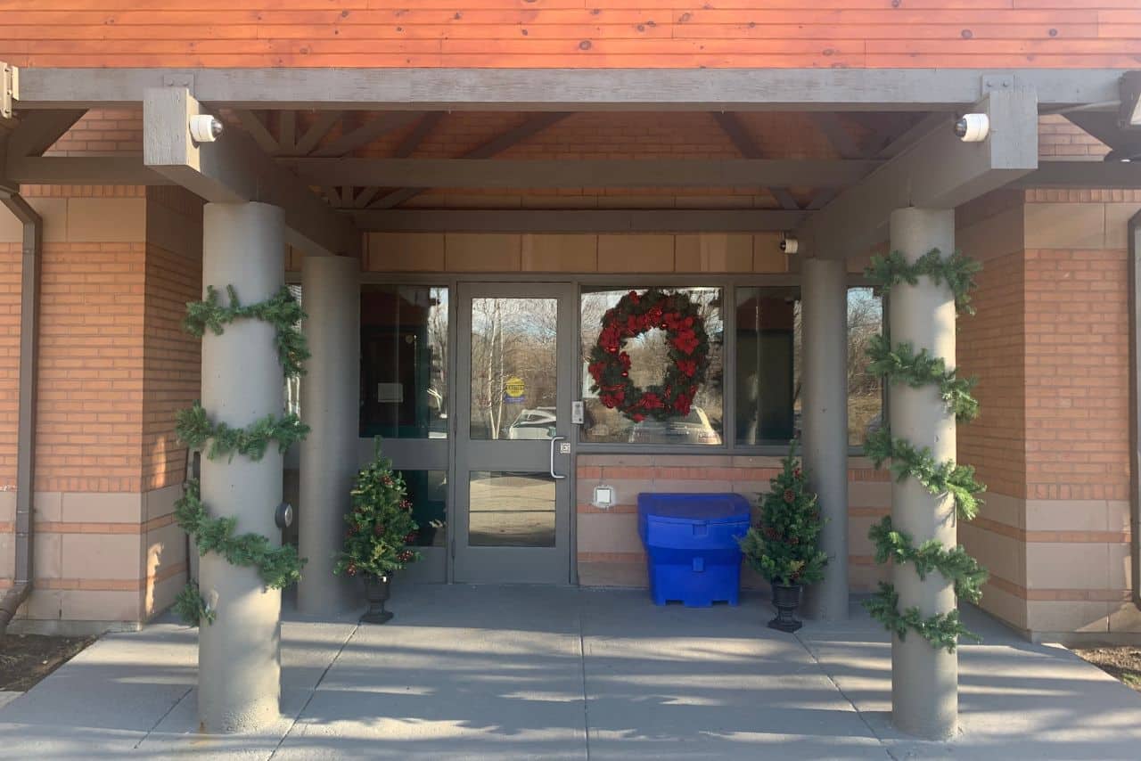 A photo of the entrance of Eva's Place decorated for the holidays
